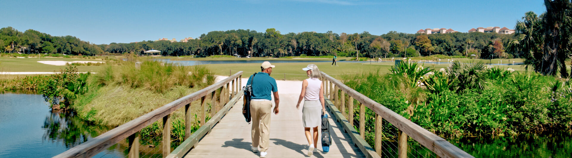 couple walking on golf course