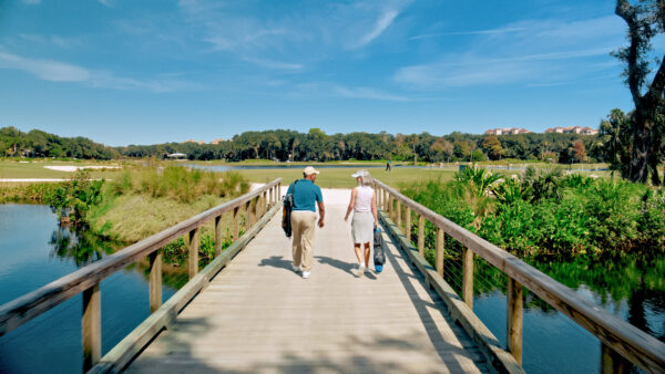 couple walking on golf course