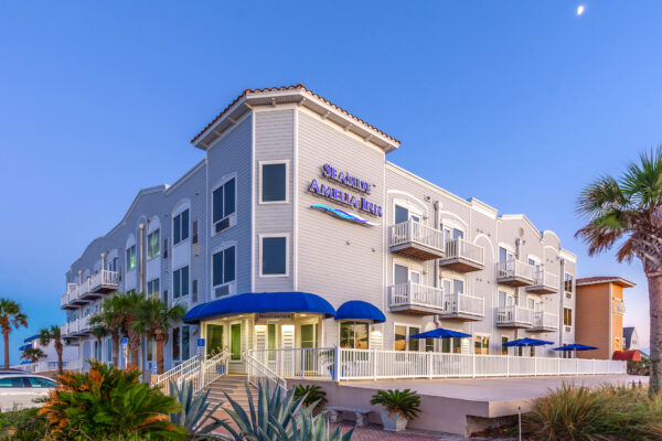 Seaside Amelia Inn exterior with umbrellas