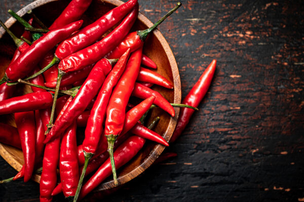 Wooden plate with hot chili peppers