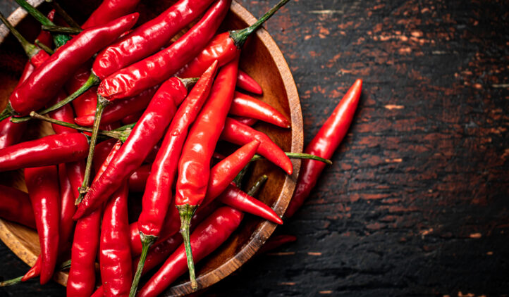 Wooden plate with hot chili peppers