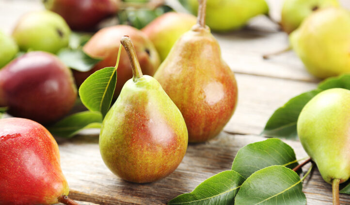 Ripe pears on grey wooden table