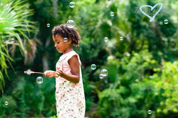 girl playing with bubbles