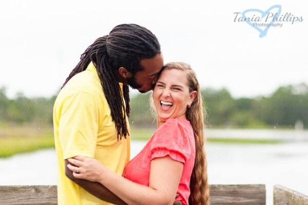 couple kissing on dock