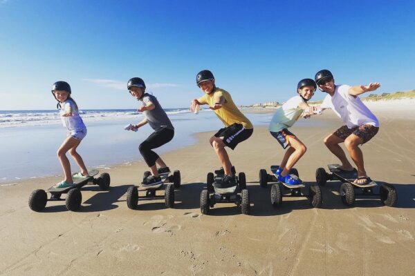 family skateboarding on beach