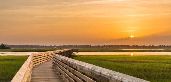 wooden boardwalk at sunset